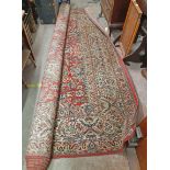 A large machine made carpet of typical floral design - size available on request