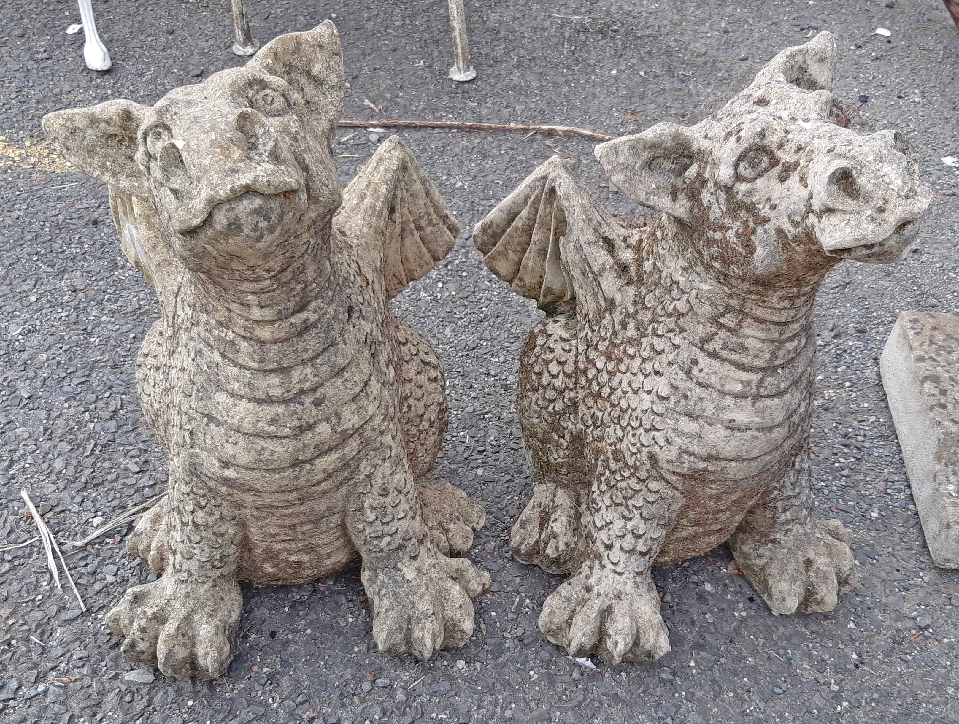 A pair of concrete dragon ornaments