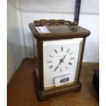 A 14cm high brass and bevelled glass cased carriage clock with dial marked for Matthew Norman,