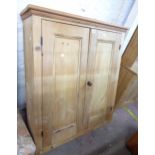 A 100cm old pine wall mounted cupboard with later top timber and shelves enclosed by a pair of