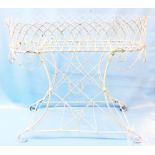 A late Regency wirework garden planter of oval form with crenulated top and scrolls, set on