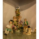 A German porcelain figural candlestick - sold with two other German porcelain figures - a/f