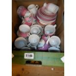 A box containing pink lustre ware, including Brixham, Princetown, etc.