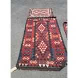 A 20th Century Pakistani kelim with repeat geometric designs on russet coloured ground - 1.8m X 1.