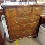 A 94cm antique mixed wood chest with burr veneer and crossbanding to top, two central drawers and