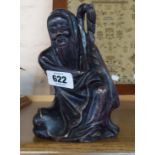 A Chinese carved soapstone figure of an Oriental man kneeling