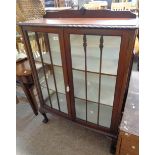 A 93cm 1920's walnut bow front display cabinet with later painted interior and animal damage to