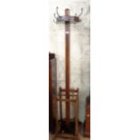 A 1930's Art Deco oak freestanding hat and coat stand with original metal drip trays - one