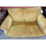 A 1.53m early 20th Century two seater settee with floral cut old gold upholstery, set on front bun