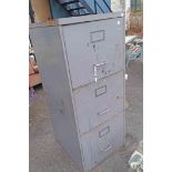 A vintage grey metal painted three drawer filing cabinet