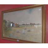 George Oyston: a gilt framed watercolour, depicting sheep grazing before a haystack with extensive