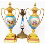 A pair of French porcelain and ormolu vases decorated in the Sevres style with central handpainted