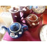 A Denby stoneware 2 1/4 blue glazed teapot, a brown glazed similar and two hot water jugs