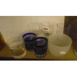 A selection of drinking glasses including an early 19th Century facet cut stem goblet, a pair of