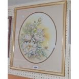 Bonia Rush: a gilt framed still life study of roses - signed, in oval mount