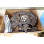 A vintage stained and carved wood cuckoo wall clock with cast metal pine cone pattern weights