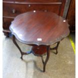 A 72cm diameter Edwardian stained walnut two tier occasional table, set on slender cabriole