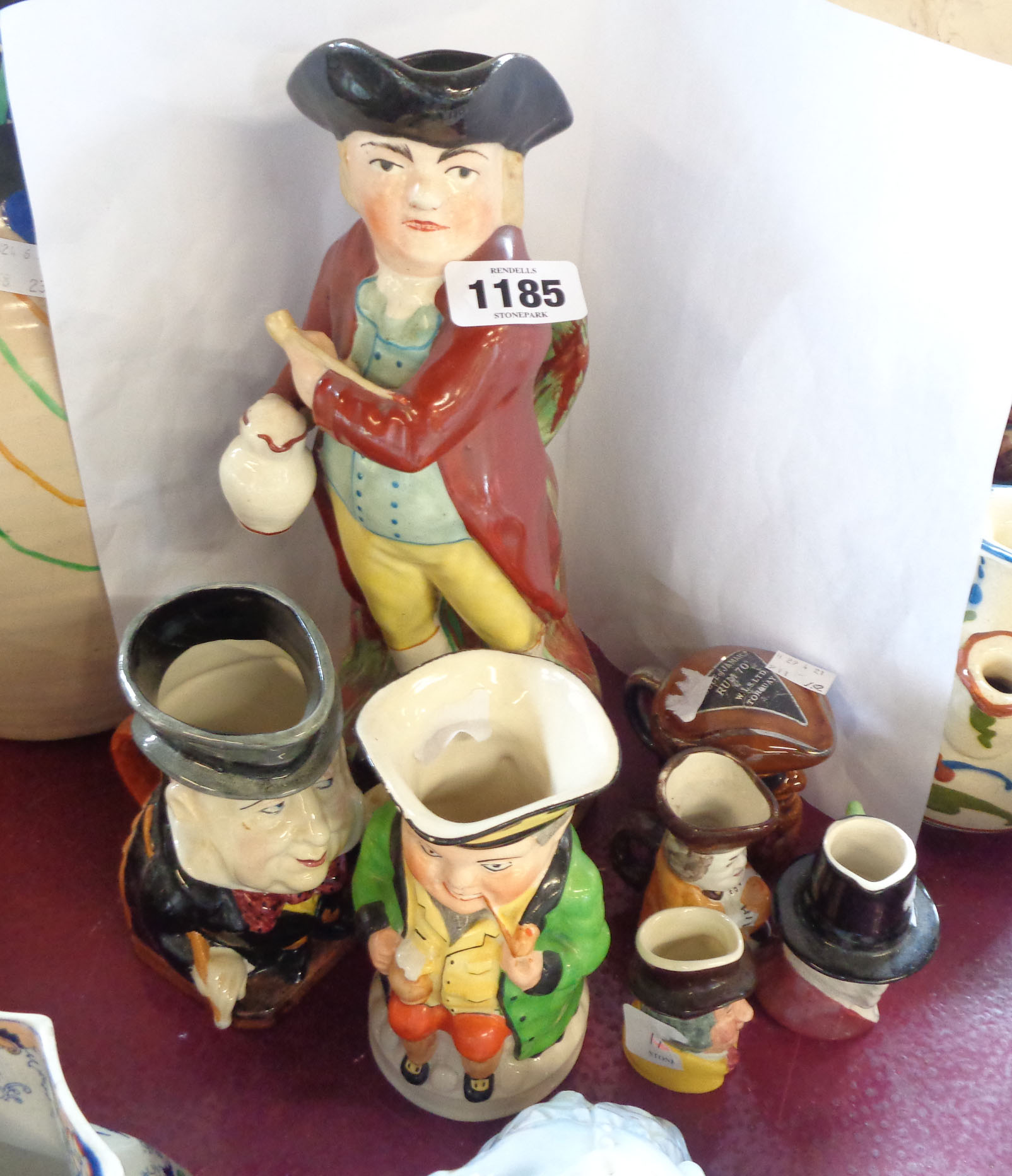 Six Toby and character jugs including Staffordshire, Burleigh ware - sold with a novelty spirit