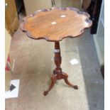 A 20th Century stained mahogany effect pedestal wine table with moulded shaped top, set on turned
