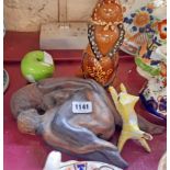 A pottery figure, an erotic pottery couple, an apple and a cat figure