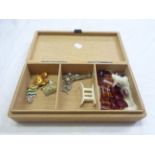 A vintage wooden cigarette box containing a small quantity of costume jewellery