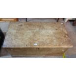 A 1.05m old pine lift-top box with flanking iron drop handles - age related wear