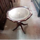 A 53cm reproduction mahogany pedestal table with glass inset top, set on tuned pillar and