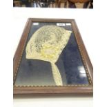 A 19th Century crochet work bridal bonnet displayed in a later picture frame