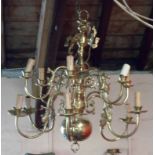 A vintage large twelve branch brass chandelier light fitting with fish decoration to sconces