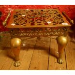 A 19th Century brass fireplace footman with front pad feet, pierced top and apron and rope twist