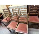 A set of six 20th Century oak framed ladder back dining chairs comprising four standard and two