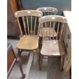 A pair of antique Windsor stick back kitchen chairs with solid moulded elm seats, set on ring turned