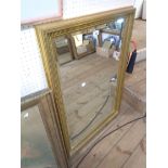 A reproduction gilt framed bevelled oblong wall mirror - 67cm X 97cm