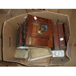 A box containing three antique box camera bodies and other old photographic items