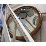 A 94cm vintage gilt framed bevelled oval wall mirror