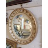 A 41cm diameter mid 20th Century parcel gilt framed convex wall mirror with beaded decoration - some