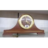 A mid 20th Century polished wood cased Napoleon hat mantel clock with floating balance eight day