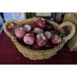 A woven basket containing a large quantity of hardstone carved fruit