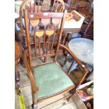 An Art Nouveau inlaid mahogany elbow chair with repeat tulip pattern splats and studded