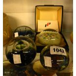 Four glass paperweights including a Caithness limited edition Sculpture weight, Caithness Orbit,