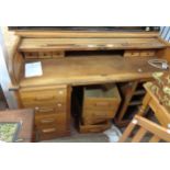 A 1.38m mid 20th Century Angus of London oak roll-top desk with drawer fitted interior, central