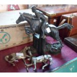 A modern Heredities bronzed resin figure of a horse and jockey jumping over a fence - sold with