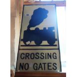 A modern reproduction painted cast iron Crossing No Gates sign