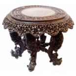 A 70cm diameter early 20th Century Burmese rosewood tiffin table with profuse carved and pierced