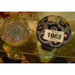 A 20th Century mille fiorie paperweight with floral ribbon round and star cut and polished base -