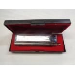 A boxed Swan 1664 chromatic harmonica