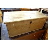 A 1.17m late Georgian pine lift-top trunk with internal candle box and original iron lock with