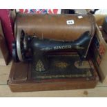 An old Singer sewing machine in wooden case
