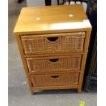 A 47cm modern polished wood boudoir chest with three wicker long drawers