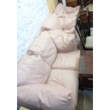 A pale pink leather upholstered three piece suite, comprising a 1.40m two seater settee and pair